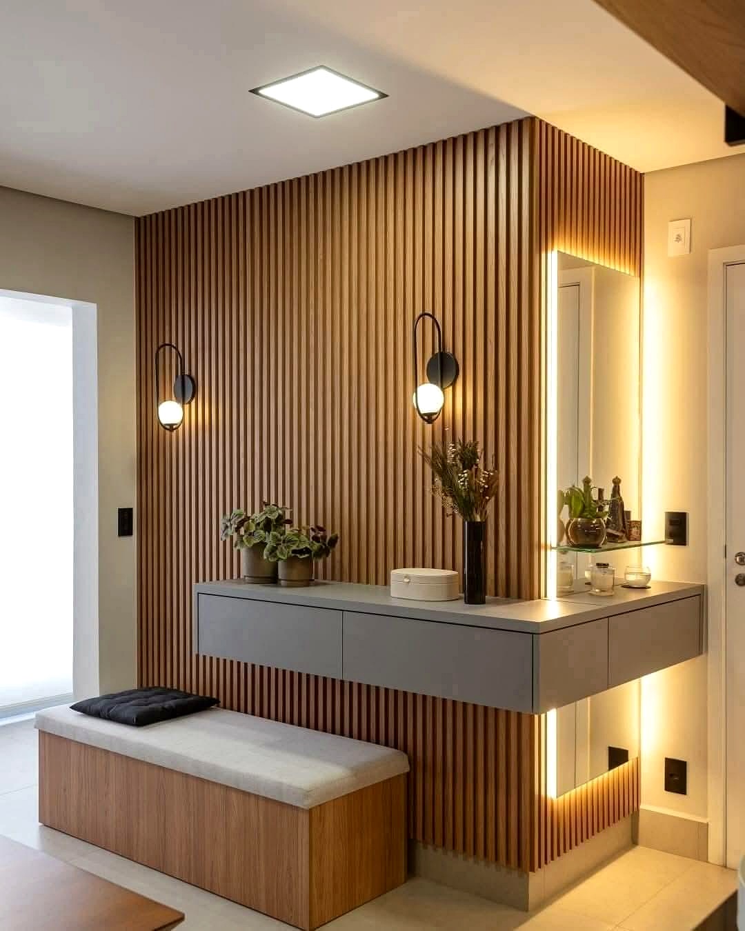 Custom entry room with wood slat wall, floating vanity, and LED lighting